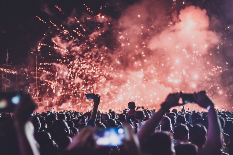 a crowd with fireworks at an event